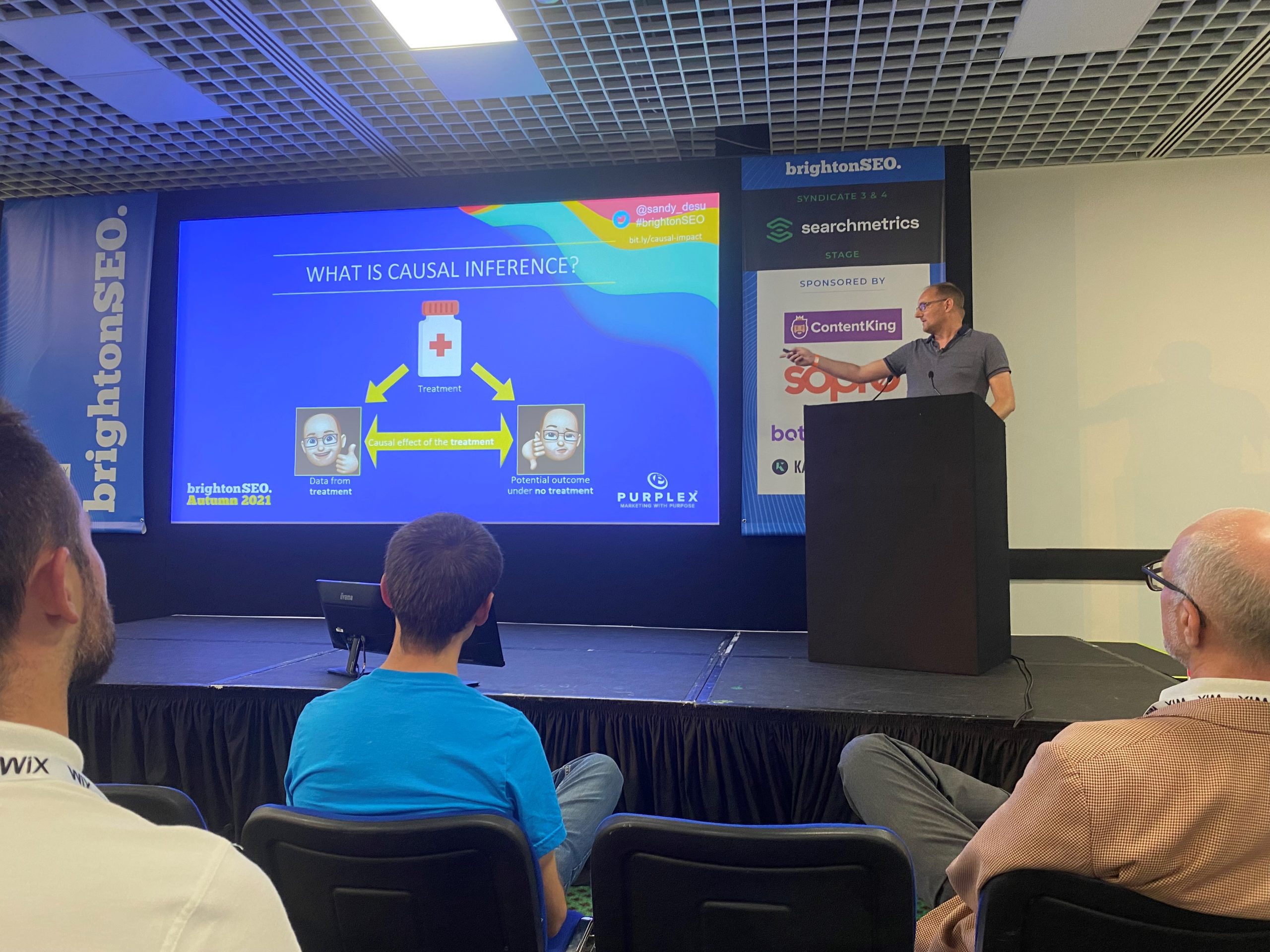 SEO expert Sandy presenting a talk at BrightonSEO, discussing causal inference in search engine optimisation.