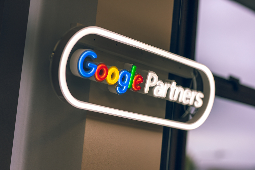 Illuminated Google Partners sign, representing SEO expertise and certified digital marketing services.