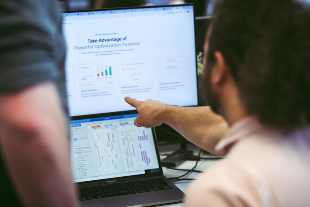 PPC management audit and optimisation reporting on screen with analyst reviewing campaign performance data