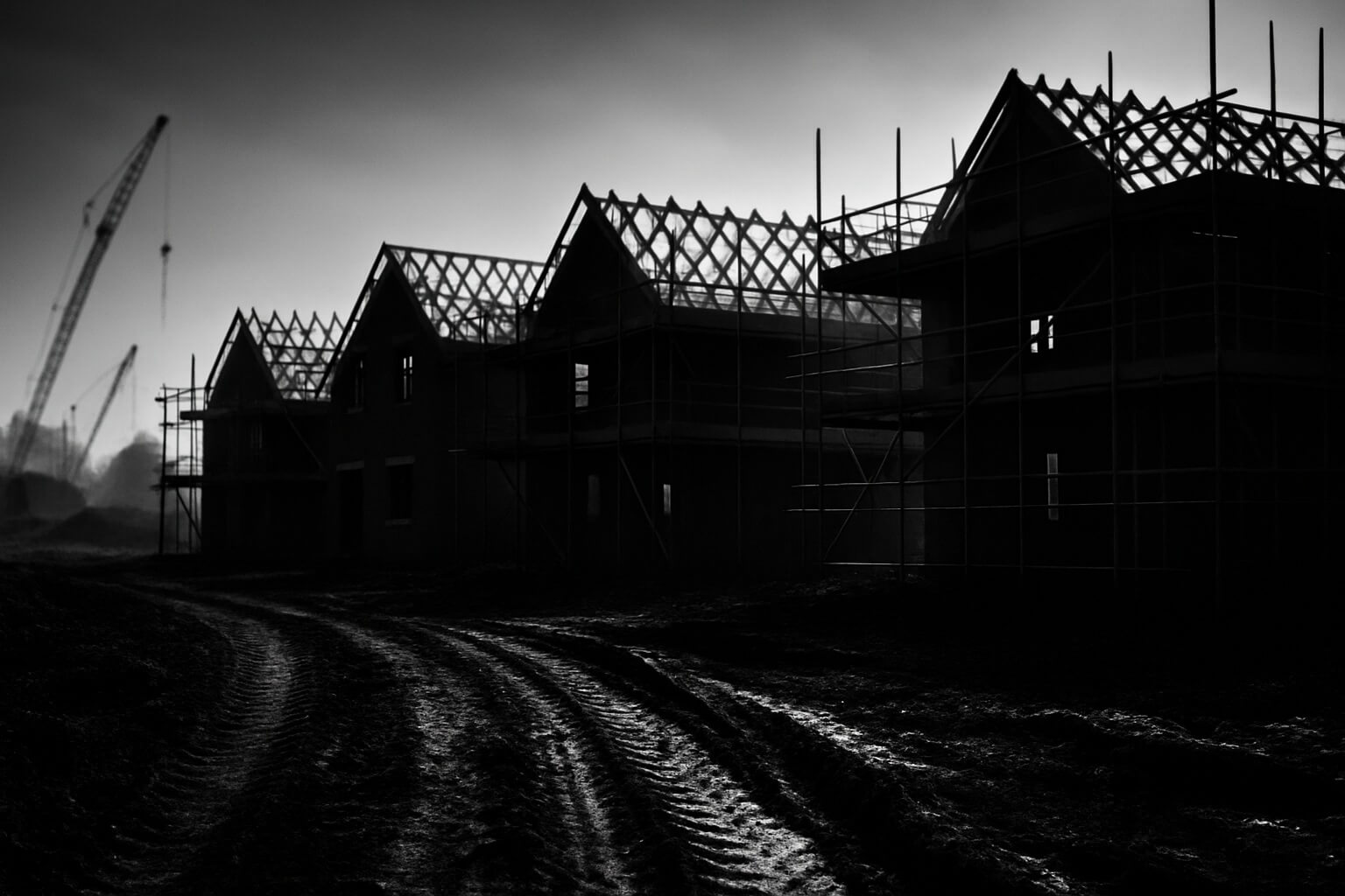 New build homes under construction in the UK with scaffolding and crane activity