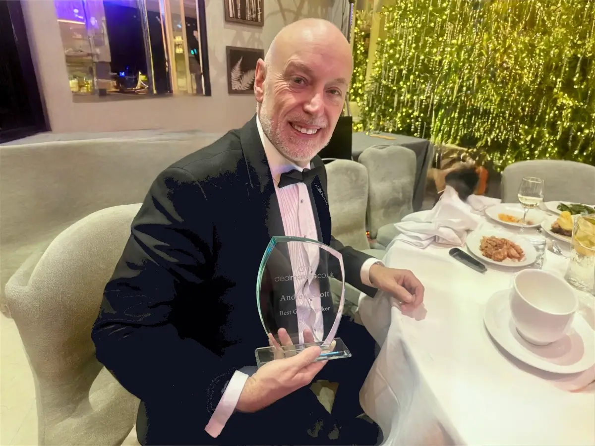 Andrew Scott holding the Guest Speaker of the Year Award at the 2025 Dealmaker Awards