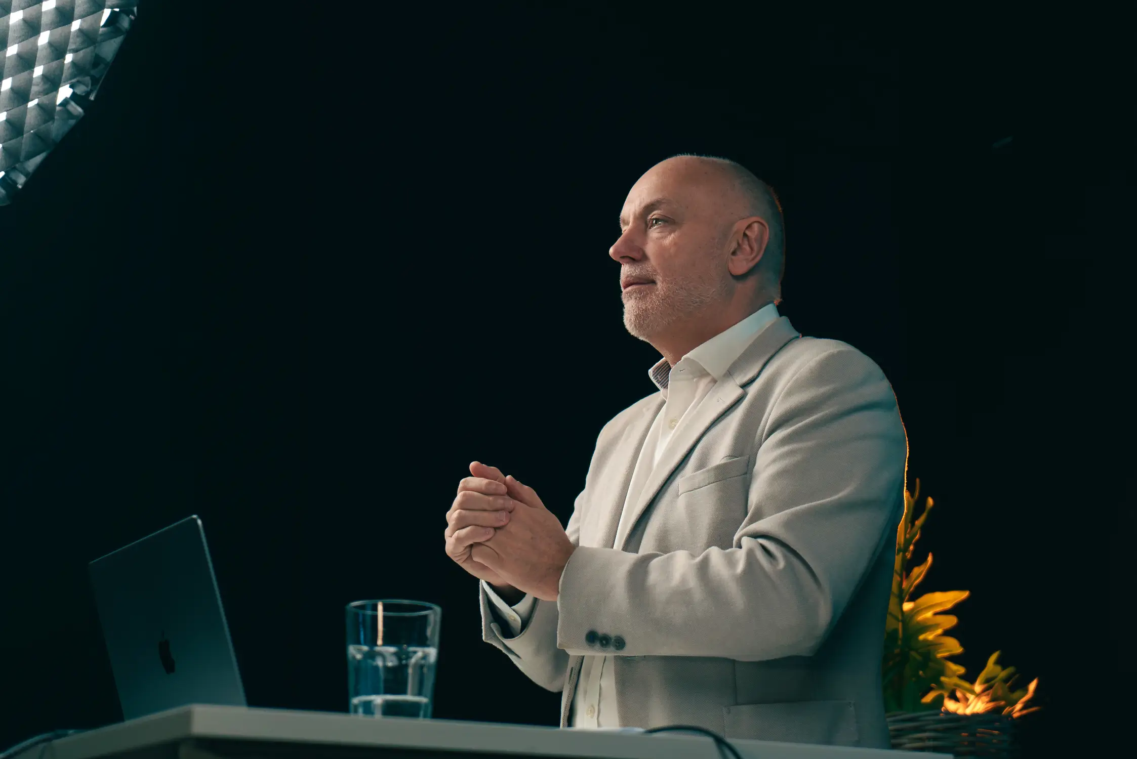 Andrew Scott presenting a glazing business growth strategy webinar in a professional studio with lighting and camera equipment