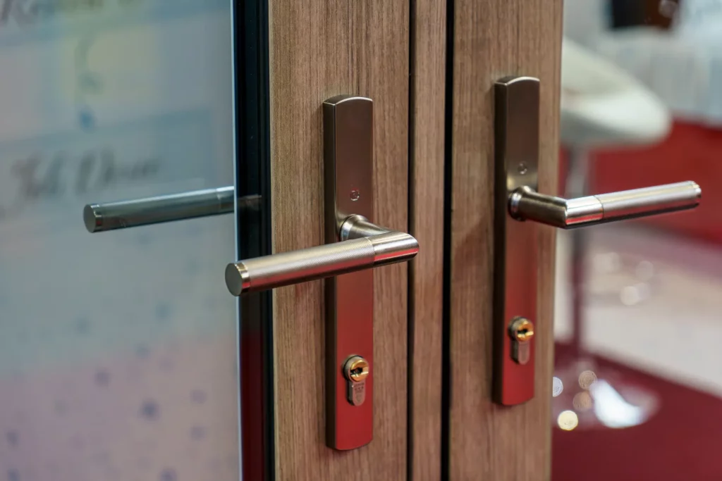 Architectural hardware marketing example showing Regal knurled door handles installed on Residence Collection doors displayed at the FIT Show.