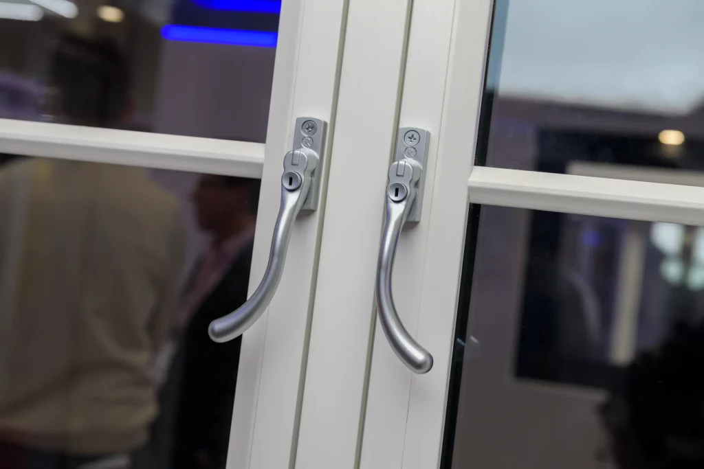 Architectural hardware marketing example showing Regal Pear window handles installed on a Kommerling flush sash window system for architectural specification and glazing hardware applications.