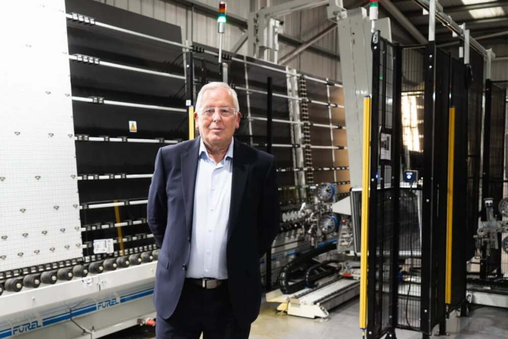 John Spiby Divisional Director of the Emplas Group and MD of Padiham Glass standing inside an IGU manufacturing facility.